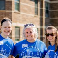Three Alumni standing together.